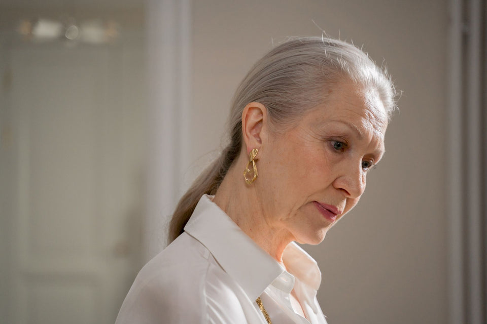 A woman with natural gray hair in soft daylight