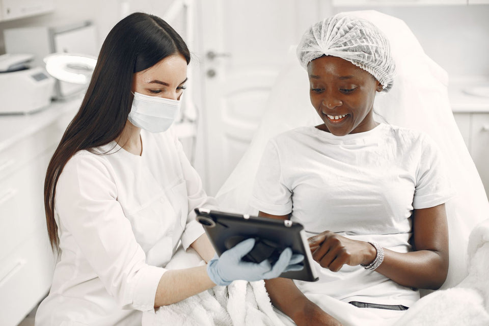 A professional and a client looking at a tablet during a consultation