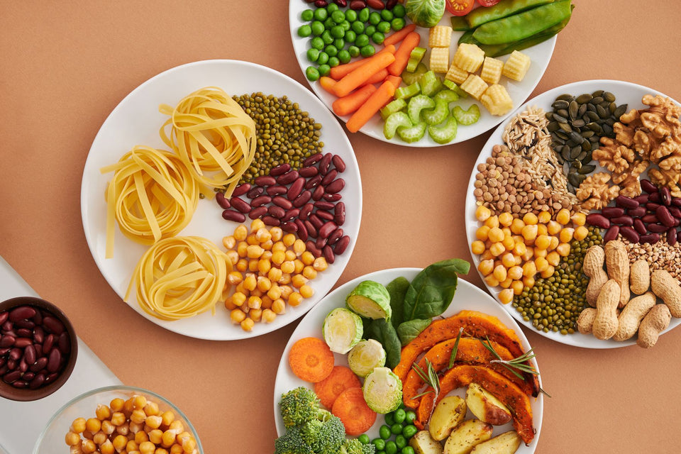 Plates of vegetables, beans, grains, nuts and seeds